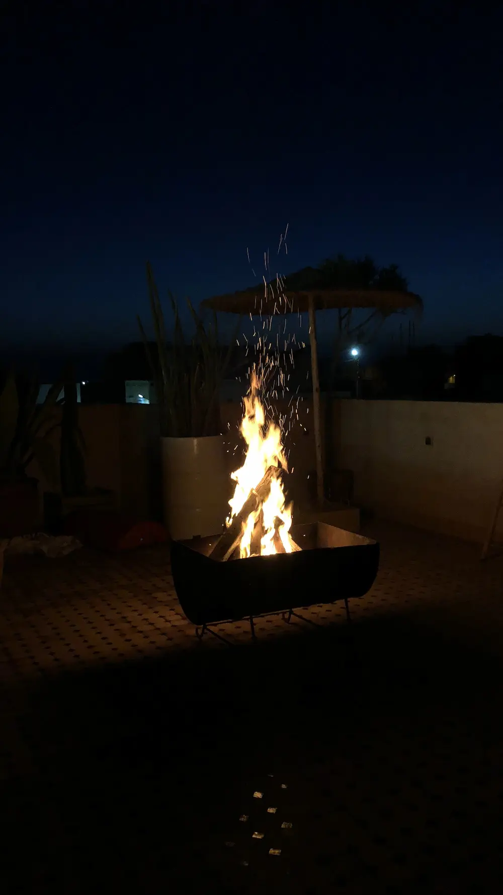 Night Patio Bonfire Fire Pit at The Yogi Surfer in Taghazout Bay, Morocco.