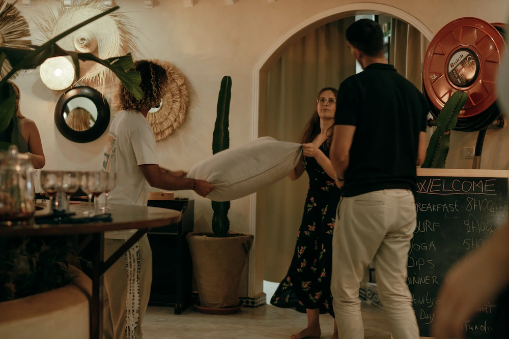 Guests Playing Pillow Game at Villa Party at The Yogi Surfer in Taghazout Bay, Morocco.