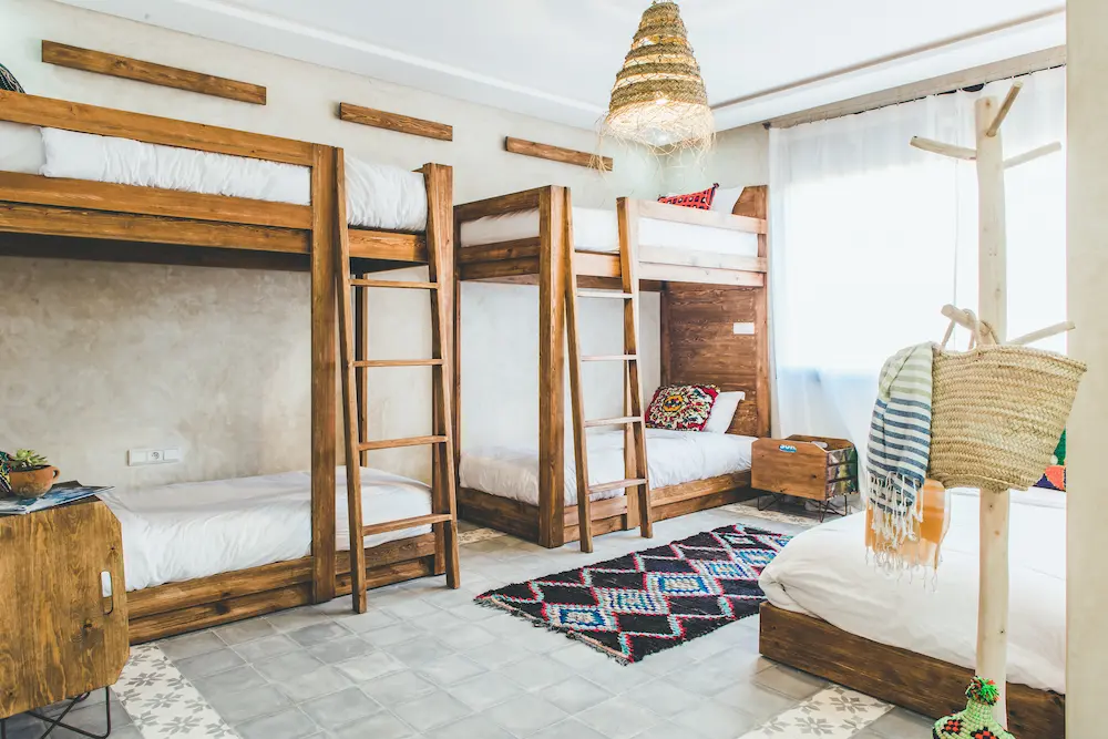 A single made-up bed in the male dorm