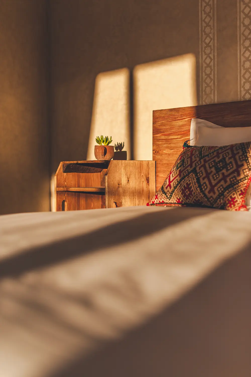 Sunrise light falling across the bed in a double ocean-view room