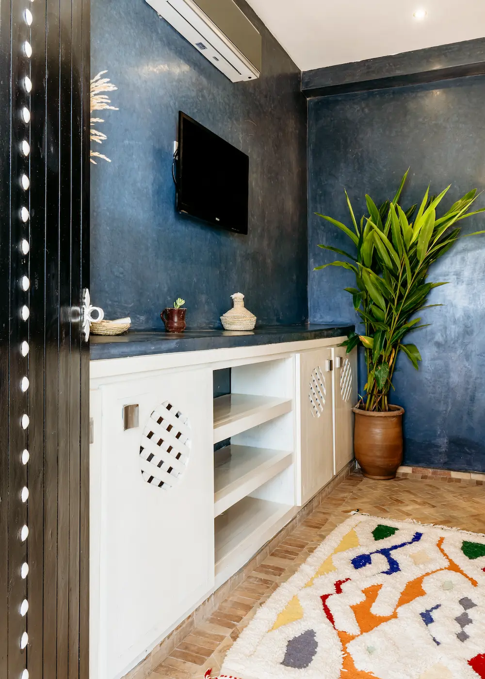 The television and wardrobe along one wall of the Moon Room
