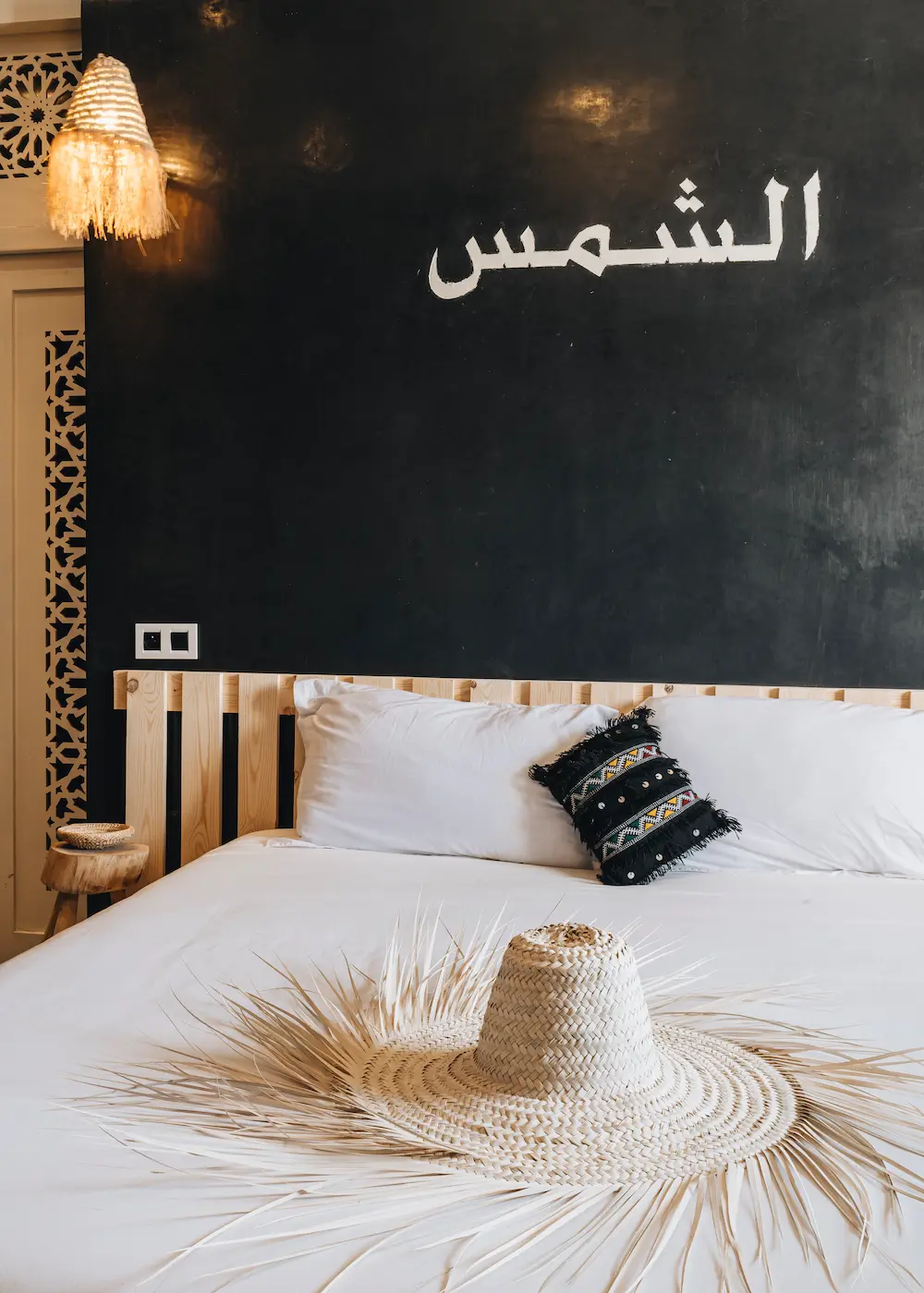 The Sun Room bed, dressed with Moroccan blankets and cushions