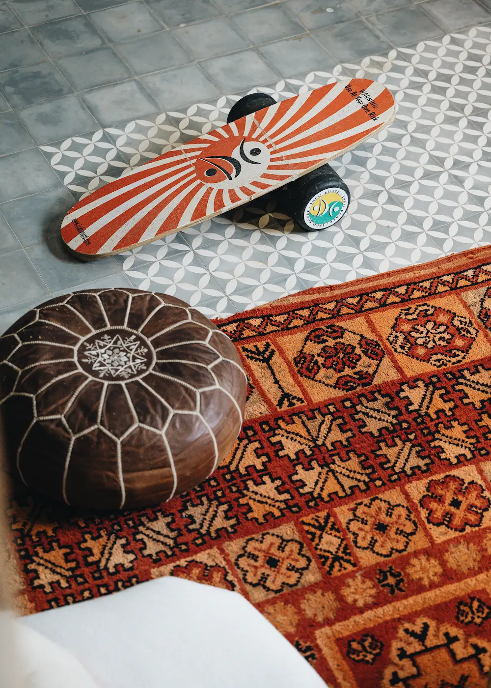 A guest practising balance on a skateboard indoors