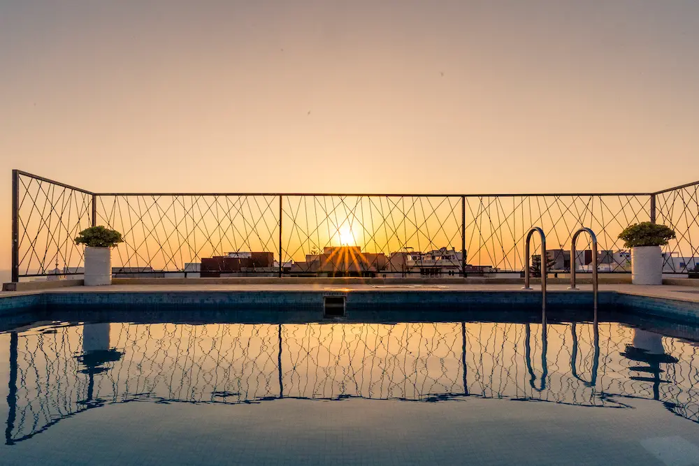 The rooftop pool at sunset, looking out over Taghazout Bay