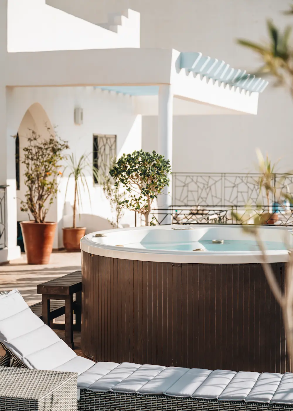 The villa roof terrace, with a hot tub and cushioned lounge seating