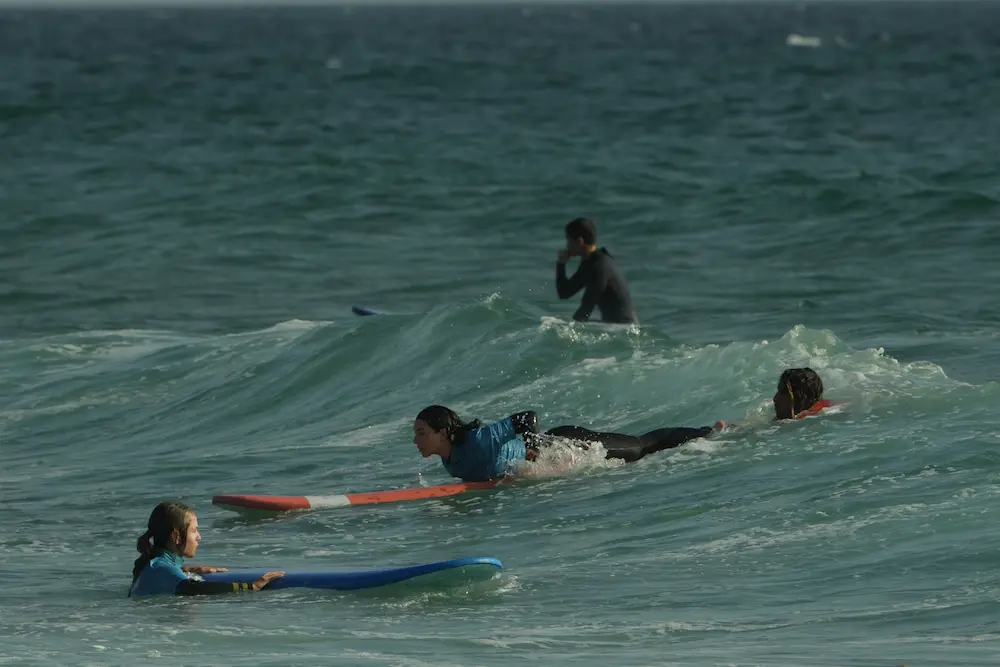 Student Catches a Wave - Surf Camp Morocco Taghazout at The Yogi Surfer in Taghazout Bay, Morocco.