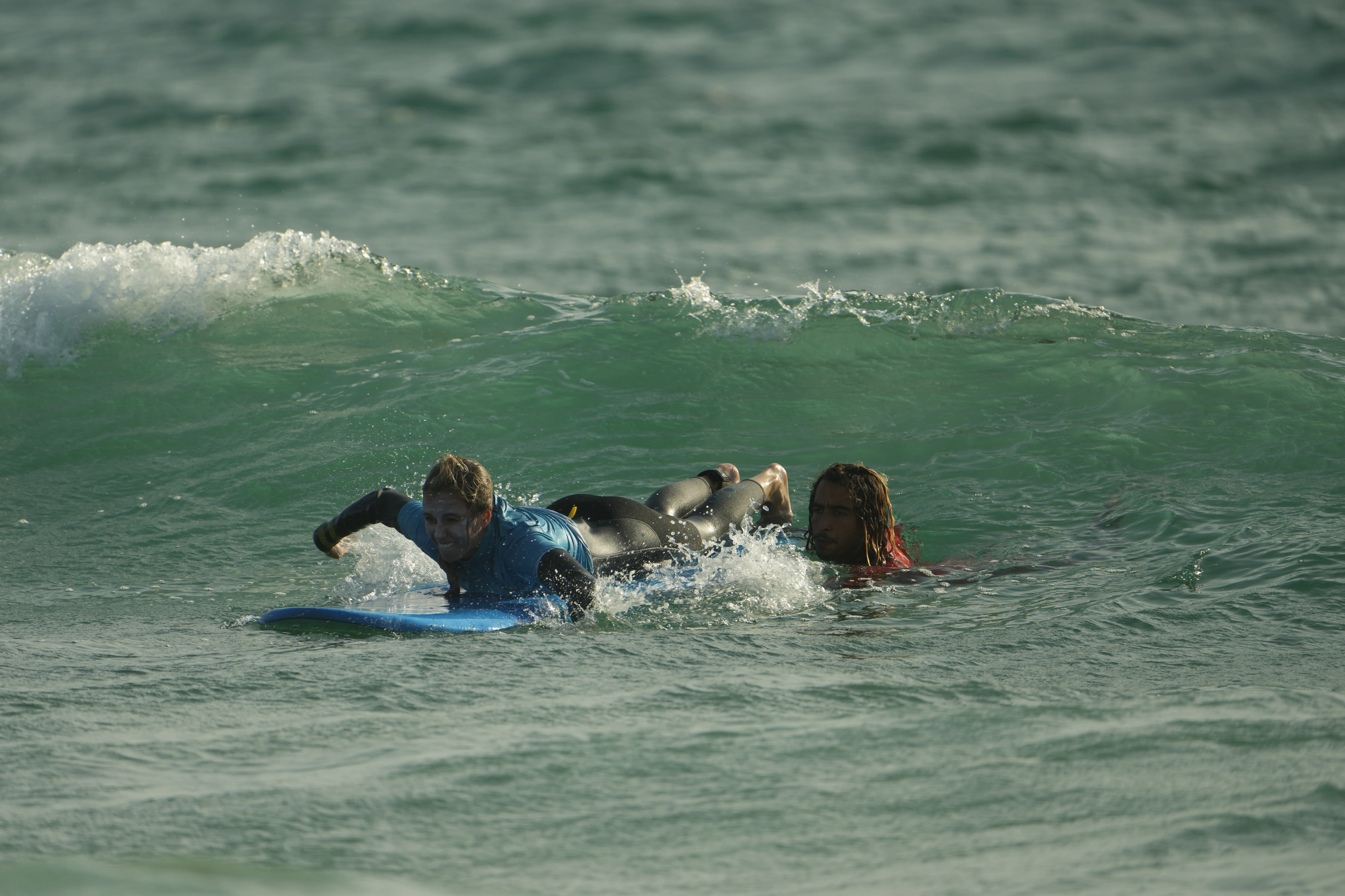 Student Paddles into a Wave - Camp Surf Taghazout at The Yogi Surfer in Taghazout Bay, Morocco.